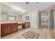 Bathroom with dual vanities, tile flooring, and an open doorway at 358 Whispering Tree Ave, Las Vegas, NV 89183