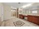 Bathroom featuring dual sinks, tiled shower, and neutral color scheme at 358 Whispering Tree Ave, Las Vegas, NV 89183