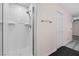 Shower stall with white tiled walls, modern fixtures, and an attached door at 358 Whispering Tree Ave, Las Vegas, NV 89183