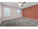 Bright bedroom featuring plush carpet, neutral walls, and ample natural light from two windows at 358 Whispering Tree Ave, Las Vegas, NV 89183