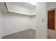 Walk-in closet featuring carpeted floors and white walls with wooden shelving at 358 Whispering Tree Ave, Las Vegas, NV 89183