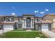Classic home design with a well-kept lawn, balanced design, and elegant double door entryway at 358 Whispering Tree Ave, Las Vegas, NV 89183
