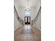 Grand foyer with a decorative tiled floor and dual staircases leading to the upper level at 358 Whispering Tree Ave, Las Vegas, NV 89183