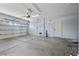 Well-lit, spacious garage with a modern door opener, side door, and ample parking area at 358 Whispering Tree Ave, Las Vegas, NV 89183