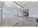 Bright garage with an automatic door opener, ample space, and a side access door at 358 Whispering Tree Ave, Las Vegas, NV 89183