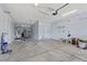 Spacious garage featuring ample storage, multiple access doors, and clean concrete floors at 358 Whispering Tree Ave, Las Vegas, NV 89183