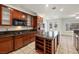 This spacious kitchen boasts stainless appliances, granite counters, island with shelving, and tile flooring at 358 Whispering Tree Ave, Las Vegas, NV 89183