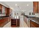 Open kitchen with a granite island, stainless appliances, and plenty of natural light at 358 Whispering Tree Ave, Las Vegas, NV 89183