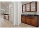 Kitchen featuring a cabinet with glass doors and granite countertops at 358 Whispering Tree Ave, Las Vegas, NV 89183