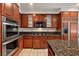 Well-equipped kitchen features granite countertops, stainless steel appliances, and ample cabinet space at 358 Whispering Tree Ave, Las Vegas, NV 89183