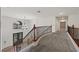 Bright landing area featuring a chandelier and railing at 358 Whispering Tree Ave, Las Vegas, NV 89183