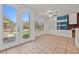 Bright living room with tile floors, a fireplace, and view of the beautiful backyard at 358 Whispering Tree Ave, Las Vegas, NV 89183