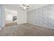 Spacious living room featuring designer wallpaper, stairs, and carpet flooring at 358 Whispering Tree Ave, Las Vegas, NV 89183