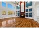 Bright living room with hardwood floors, fireplace, high ceilings, and natural light from large windows at 358 Whispering Tree Ave, Las Vegas, NV 89183