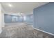 Expansive living area featuring plush carpets, natural light, and neutral paint at 358 Whispering Tree Ave, Las Vegas, NV 89183