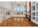Spacious living room boasts hardwood floors, fireplace, and large windows offering plenty of natural light at 358 Whispering Tree Ave, Las Vegas, NV 89183