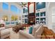 Bright and open living room with hardwood floors, fireplace, and large windows at 358 Whispering Tree Ave, Las Vegas, NV 89183