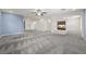 Spacious living room featuring plush gray carpeting and a modern fireplace at 358 Whispering Tree Ave, Las Vegas, NV 89183