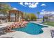 Outdoor pool featuring a rock waterfall, tropical inspired cabana, and a barbecue at 358 Whispering Tree Ave, Las Vegas, NV 89183