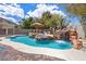 Inviting pool with a waterfall and tropical landscaping creating a serene backyard retreat at 358 Whispering Tree Ave, Las Vegas, NV 89183