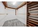 Walk-in closet with custom shelving and gray carpeting at 358 Whispering Tree Ave, Las Vegas, NV 89183