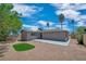 View of the backyard with concrete patio and small grass area surrounded by gravel at 416 Rossmoyne Ave, North Las Vegas, NV 89030