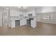 Bright kitchen with white cabinets, stainless steel appliances, and wood look floors at 416 Rossmoyne Ave, North Las Vegas, NV 89030