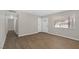 Open-concept living area featuring neutral paint and modern wood-look tile floors at 416 Rossmoyne Ave, North Las Vegas, NV 89030