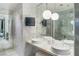 Bright bathroom with marble vanity, double sinks, and modern lighting fixtures at 4381 W Flamingo Rd # 2122, Las Vegas, NV 89103