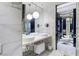 Elegant bathroom with double sinks, marble countertop, and modern lighting fixtures at 4381 W Flamingo Rd # 2122, Las Vegas, NV 89103