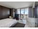 Modern bedroom with a soaking tub, floor-to-ceiling windows, and a seating area overlooking the city at 4381 W Flamingo Rd # 2122, Las Vegas, NV 89103