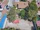 Aerial view of the property featuring a spacious backyard, mature trees, and tennis court at 4409 W Red Coach Ave, North Las Vegas, NV 89031