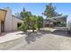 Spacious backyard with a covered parking area, beautiful landscaping, and room for outdoor activities at 4409 W Red Coach Ave, North Las Vegas, NV 89031