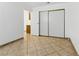 Simple bedroom featuring tile floors and a closet at 4409 W Red Coach Ave, North Las Vegas, NV 89031