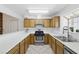 Efficient kitchen with stainless steel gas range, abundant counter space, and oak cabinetry at 4409 W Red Coach Ave, North Las Vegas, NV 89031
