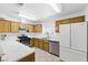 Functional kitchen featuring wood cabinets, stainless steel appliances, and a bright window above the sink at 4409 W Red Coach Ave, North Las Vegas, NV 89031