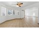 Expansive living area features tiled floors, a ceiling fan, and a connecting doorway at 4409 W Red Coach Ave, North Las Vegas, NV 89031