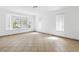 Bright, airy living room featuring neutral tones, large bay windows, and tiled floors at 4409 W Red Coach Ave, North Las Vegas, NV 89031