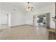 Bright living room featuring tile floors, a ceiling fan, and a sliding glass door to the backyard at 4409 W Red Coach Ave, North Las Vegas, NV 89031