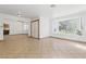Bright living room with tiled flooring, natural light, and a view of the front yard at 4409 W Red Coach Ave, North Las Vegas, NV 89031