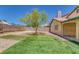 Expansive backyard featuring green lawn and a young tree, all enclosed by a block wall at 4619 Reliant St, North Las Vegas, NV 89031