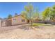 Large backyard with lawn, desert landscaping, patio, and block wall provides ample room at 4619 Reliant St, North Las Vegas, NV 89031