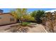 Large backyard with artificial turf, desert landscaping, mature trees, and block wall at 4619 Reliant St, North Las Vegas, NV 89031