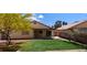 Nice backyard featuring a covered patio, artificial turf, desert landscaping, and mature trees at 4619 Reliant St, North Las Vegas, NV 89031