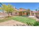 Backyard features green lawn area, desert landscaping, patio space, and secure block wall at 4619 Reliant St, North Las Vegas, NV 89031