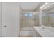 Bathroom featuring a single sink vanity, shower-tub combo, and a tiled wall at 4619 Reliant St, North Las Vegas, NV 89031