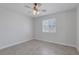 Neutral bedroom with tiled floor, a ceiling fan, and a bright window at 4619 Reliant St, North Las Vegas, NV 89031