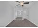 Bedroom featuring carpet flooring, ceiling fan, closet with sliding mirrored doors, and access to an additional room at 4619 Reliant St, North Las Vegas, NV 89031