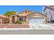 Inviting single-story home with a charming tiled roof, two-car garage, and desert landscaping in a vibrant community at 4619 Reliant St, North Las Vegas, NV 89031