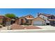 Cozy home featuring a tile roof, manicured landscape, and convenient two-car garage at 4619 Reliant St, North Las Vegas, NV 89031